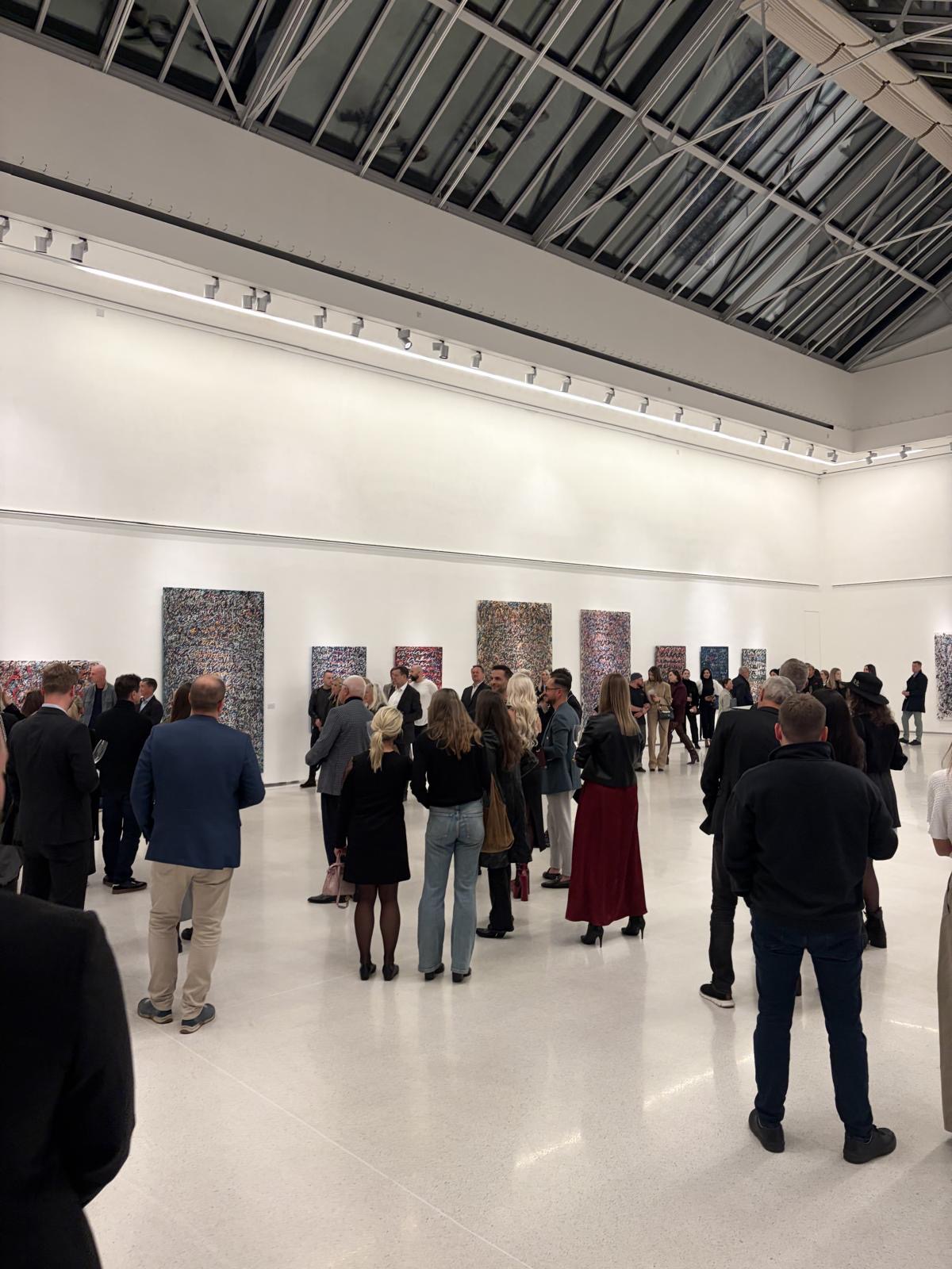 Visitors viewing Anima Mundi during the opening at Galerie Mánes