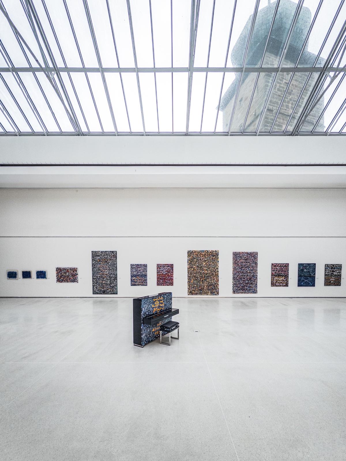 PETROF Gemini surrounded by Anima Mundi paintings in the main hall at Galerie Mánes